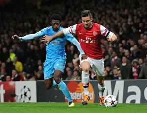 Arsenal V Marseille 2013-14 Prints: Arsenal's Olivier Giroud Clashes with Marseille's Nicolas N'Koulou in Champions League Showdown