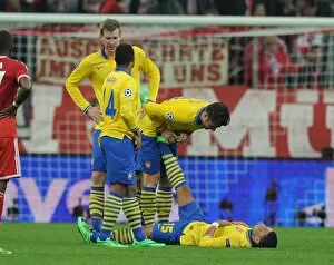 Images Dated 11th March 2014: Arsenal's Olivier Giroud Comforts Oxlade-Chamberlain During Bayern Munich Clash in Champions League