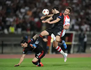 Arsenal's Olivier Giroud Faces Off Against Besiktas Defenders Ersan Gulum and Pedro Franco in UEFA Champions League Qualifier