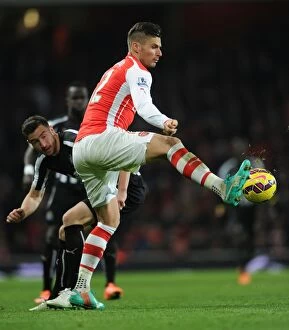 Arsenal v Newcastle United 2014/15 Collection: Arsenal's Olivier Giroud Faces Off Against Newcastle's Paul Dummett in Intense Premier League Clash