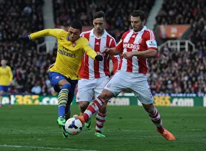 Stoke City V Arsenal 2013-14 Prints: Arsenal's Oxlade-Chamberlain Brakes Past Stoke's Peiters and Arnautovic