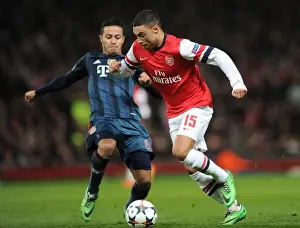 Arsenal V Bayern Munich 2013-14 Prints: Arsenal's Oxlade-Chamberlain Clashes with Bayern's Thiago in Champions League Showdown