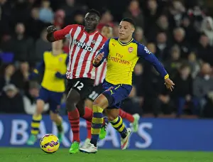 Southampton V Arsenal 2014-15 Prints: Arsenal's Oxlade-Chamberlain Clashes with Southampton's Wanyama in Premier League Showdown (January 2015)