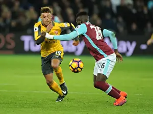 West Ham United V Arsenal 2016-17 Prints: Arsenal's Oxlade-Chamberlain Clashes with West Ham's Masuaku in Premier League Showdown