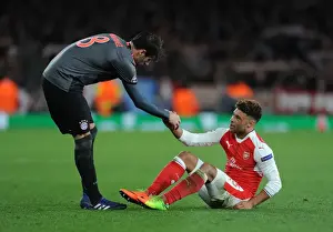 Arsenal's Oxlade-Chamberlain Consoled by Bayern's Javi Martinez in UEFA Champions League Clash