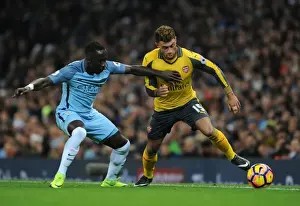 Manchester City V Arsenal 2016-17 Prints: Arsenal's Oxlade-Chamberlain Faces Off Against Man City's Sagna in Premier League Clash (2016-17)