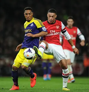 Arsenal's Oxlade-Chamberlain Faces Off Against Swansea's De Guzman