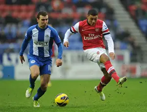 Wigan Athletic V Arsenal 2012-13 Prints: Arsenal's Oxlade-Chamberlain Fouls by McArthur in Wigan Clash (2012-13)