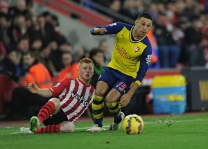 Southampton v Arsenal 2014-15 Collection: Arsenal's Oxlade-Chamberlain Outmaneuvers Southampton's Reed in Premier League Clash (January 2015)