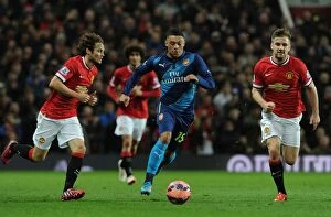 Images Dated 13th February 2009: Arsenal's Oxlade-Chamberlain Outsmarts Manchester United's Shaw