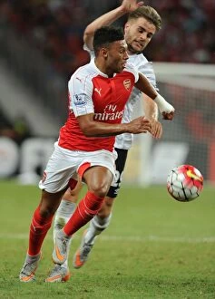 Images Dated 18th July 2015: Arsenal's Oxlade-Chamberlain Outwits Garbutt in Barclays Asia Trophy Clash