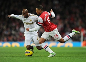 Arsenal V Swansea 2012-13 Prints: Arsenal's Oxlade-Chamberlain vs. Swansea's Tiendalli: A Premier League Battle