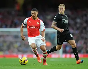 Arsenal V Burnley 2014/15 Prints: Arsenal's Oxlade-Chamberlain vs Burnley's Arfield: A Football Showdown