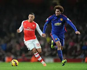Arsenal V Manchester United 2014-15 Prints: Arsenal's Oxlade-Chamberlain vs Manchester United's Fellaini: A Premier League Showdown at Emirates Stadium