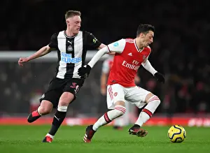 Arsenal V Newcastle United 2019-20 Prints: Arsenal's Ozil Clashes with Newcastle's Longstaff in Premier League Showdown