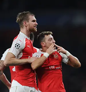 Arsenal V Bayern Munich 2015/16 Prints: Arsenal's Ozil and Mertesacker Celebrate Goals Against Bayern Munich in 2015 Champions League Match