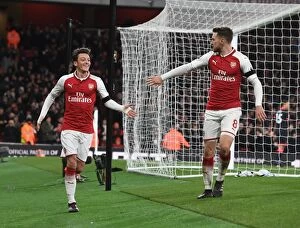 Arsenal v Huddersfield Town 2017-18 Collection: Arsenal's Ozil and Ramsey Celebrate Third Goal vs. Huddersfield Town, 2017-18 Season