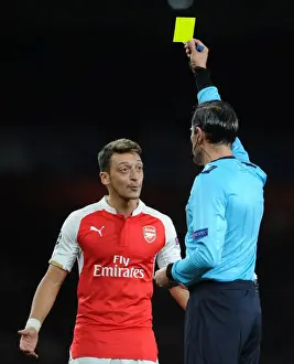 Arsenal V Olympiacos 2015/16 Prints: Arsenal's Ozil Receives Yellow Card vs Olympiacos in Champions League (2015/16)