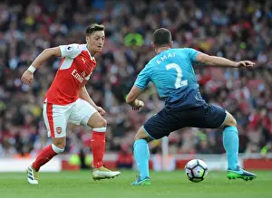 Arsenal V Swansea City 2016-17 Prints: Arsenal's Ozil Slips Past Swansea's Amat in Premier League Showdown