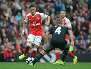 Arsenal V Southampton 2016-17 Prints: Arsenal's Ozil vs. Southampton's Clasie: A Battle in the 2016-17 Premier League