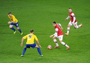 Images Dated 24th January 2014: Arsenal's Ozil and Wilshere Charge Forward Against Coventry's Fleck