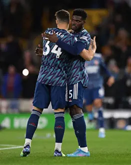 Arsenal's Partey and Xhaka Embrace Amidst Premier League Battle: Wolverhampton Wanderers vs Arsenal (2021-22)