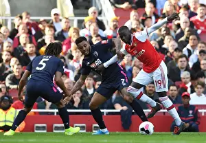 Arsenal's Pepe Clashes with Bournemouth's King and Ake during the 2019-20 Premier League Match