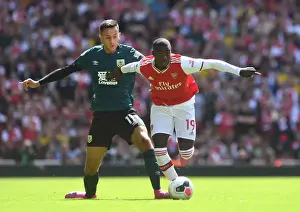 Arsenal's Pepe Clashes with Burnley's McNeil in Premier League Showdown