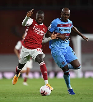 Images Dated 19th September 2020: Arsenal's Pepe Clashes with West Ham's Ogbonna in Premier League Showdown