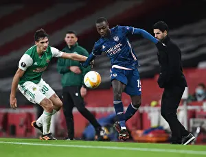 Arsenal's Pepe Faces Off in Empty Emirates: A UEFA Europa League Showdown against Rapid Wien, 2020