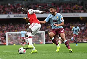 Arsenal V Aston Villa 2019-20 Prints: Arsenal's Pepe Faces Off Against Villa's Taylor in Premier League Clash