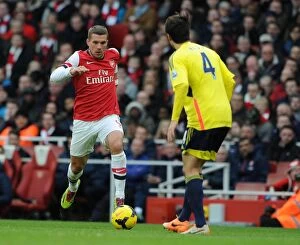 Images Dated 22nd February 2014: Arsenal's Podolski Takes On Sunderland's Ki in Premier League Clash
