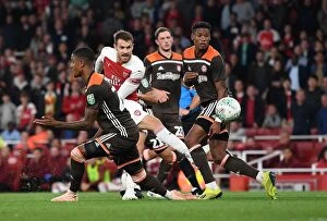 Images Dated 26th September 2018: Arsenal's Ramsey Faces Off Against Brentford's Jeanvier in Carabao Cup Clash