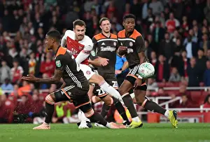 Arsenal V Brentford - Carabao Cup 2018-19 Prints: Arsenal's Ramsey Faces Off Against Brentford's Jeanvier in Carabao Cup Clash
