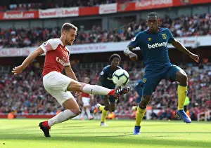 Arsenal V West Ham United 2018-19 Prints: Arsenal's Ramsey Faces Off Against West Ham's Diop in Premier League Clash