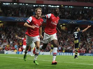 Uefa Champions Laegue Collection: Arsenal's Ramsey and Sanogo: United in Victory - Celebrating Goals in the 2013-14 UEFA Champions