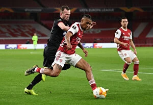 Images Dated 29th October 2020: Arsenal's Reiss Nelson Clashes with Dundalk's Cameron Dummigan in Empty Emirates Stadium - UEFA