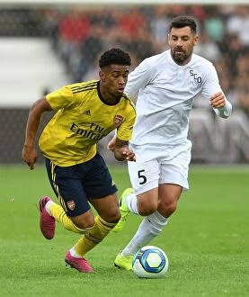 Images Dated 31st July 2019: Arsenal's Reiss Nelson Faces Off Against Angers Thomas Mangani in 2019 Pre-Season Friendly