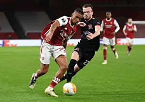Arsenal V Dundalk 2020-21 Prints: Arsenal's Reiss Nelson Goes Head-to-Head with Dundalk's Cameron Dummigan in Empty Emirates Stadium - UEFA