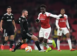 Arsenal V Qarabag 2018-19 Prints: Arsenal's Rising Star Bukayo Saka Goes Head-to-Head with Qarabag's Defender Gara Gareyev in Europa League