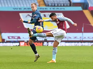 Arsenal's Rob Holding Blocks Aston Villa's Mahmoud Trezeguet: A Premier League Clash Amidst COVID-19 Restrictions