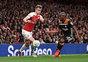 Images Dated 26th September 2018: Arsenal's Rob Holding Clashes with Brentford's Moses Odubajo in Carabao Cup Showdown