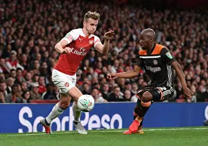 Arsenal V Brentford - Carabao Cup 2018-19 Prints: Arsenal's Rob Holding Clashes with Brentford's Moses Odubajo in Carabao Cup Showdown