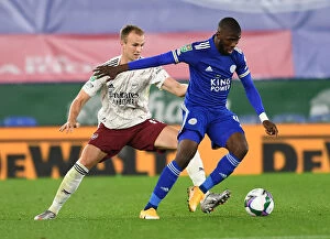 Leicester City v Arsenal Carabao Cup 2020-21 Collection: Arsenal's Rob Holding Closes In on Leicester's Kelechi Iheanacho in Carabao Cup Clash