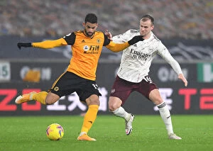 Wolverhampton Wanderers v Arsenal 2020-21 Collection: Arsenal's Rob Holding Closes In on Wolverhampton's Willian Jose in Intense Premier League Clash
