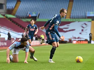 Arsenal's Rob Holding Outmaneuvers Aston Villa's John McGinn in Empty Villa Park