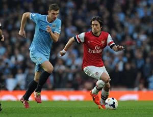 Images Dated 29th March 2014: Arsenal's Rosicky Outmaneuvers Manchester City's Dzeko in Thrilling Premier League Clash