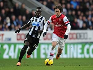 Newcastle United Collection: Arsenal's Rosicky Outsmarts Tiote: Agile Moves in the 2013-14 Arsenal-Newcastle Midfield Battle