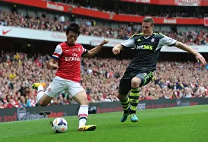Arsenal V Stoke City 2013-14 Prints: Arsenal's Ryo Miyaichi Faces Off Against Stoke's Robert Huth