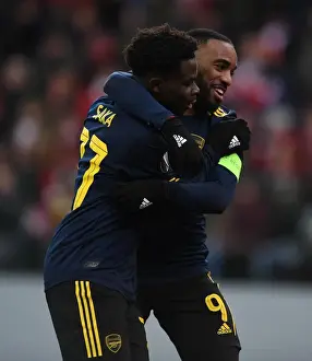 Standard Liege V Arsenal 2019-20 Prints: Arsenal's Saka and Lacazette: Celebrating Goals in Europa League Victory over Standard Liege